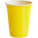A close up of a yellow plastic cup.