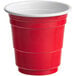 A red plastic Choice shot cup with a white rim.