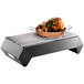 A black matte steel Rosseto Multi-Chef chafer alternative pan of food on a grill.