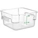 A clear square polycarbonate food storage container with green writing.