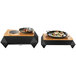 A black Rosseto Multi-Chef chafer alternative warmer base with food on a table.
