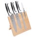 A set of Mercer Culinary Millennia® knives on a wooden block with white accents.