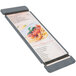 A Menu Solutions customizable wood menu board with rubber band straps holding a menu of pasta.