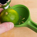 A person using a Chef'n FreshForce lime juicer to squeeze a lime.