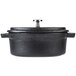 A close-up of a black Libbey mini cast iron pot with a lid.