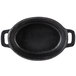 A black oval cast iron dish with handles.
