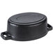 A black cast iron oval Dutch oven with a lid.