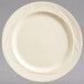 A Libbey round cream white medium rim china plate with a swirl design on the rim.