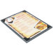 A Menu Solutions customizable wood menu board on a table.