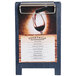 A Menu Solutions denim wood sandwich menu board tent with a clip on a wood stand on a table with a glass of red wine.