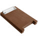 A brown wooden Menu Solutions clipboard with a metal clip on a table.