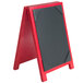A red and black wood Menu Solutions table tent with picture corners on a table.