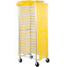 A yellow and white Curtron Supro breathable mesh bun pan rack cover on a metal rack.