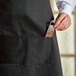 A person holding a knife in a pocket of a Choice Men's Server Tuxedo Set.