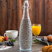 Acopa 32 oz. Textured Glass Water Bottle with Clear Swing Top Lid - 6/Case Main Thumbnail 1