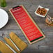A customizable wood Menu Solutions clip board on a table with a fork and knife.