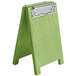A green wooden Menu Solutions clipboard with a silver clip.