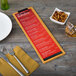 A customizable wood menu clip board on a table with a fork and knife.