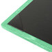 A teal wood menu board with black and green corners on a table.