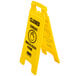 A yellow Rubbermaid wet floor sign with black multi-lingual text reading "Closed" and "Clear" on a white background.