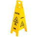 A yellow Rubbermaid wet floor sign with black text reading "Caution Wet Floor" on a white background.