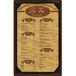 A Menu Solutions walnut wood menu board with picture corners holding a menu on brown paper.
