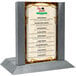 A Menu Solutions wooden menu holder with an ash wood frame on a table.