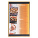 A Menu Solutions customizable wood menu board with top and bottom strips on a table with a variety of food.
