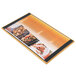 A Menu Solutions customizable wood menu board with top and bottom strips on a table with a plate of food with shrimp.