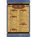 A customizable wood menu board with blue rubber band straps holding a menu with brown text.