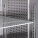 A metal grid shelf with holes for a Continental Reach-In Refrigerator.