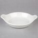 A Hall China au gratin dish with white surface and handles.