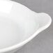 A Hall China bright white au gratin dish with a handle.