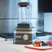 A KitchenAid Dark Pewter commercial blender on a counter.