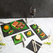 A table with a variety of food items on Acopa rectangular black slate trays.