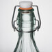 An Arcoroc Swing Top Tinted Green Glass Bottle with a metal cap.