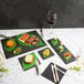 A table with different food items on a Acopa black slate tray with a glass of wine.