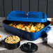 A blue GET Heiss roasting pan with food in it.