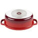 A red and white enamel oval dutch oven with a lid.