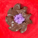 A chocolate swirl with purple frosting made using an Ateco Russian Piping Tip.
