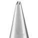 A silver metal cone shaped Ateco piping tip with a small hole.