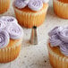 Cupcakes with purple frosting piped using an Ateco open star piping tip.