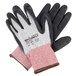 A pair of black and white Cordova Machinist cut resistant gloves with black foam nitrile palms and red and gray stripes.