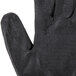 A close-up of a pair of Cordova black cut resistant work gloves with black foam nitrile palms.