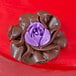 A purple chocolate flower made with an Ateco Russian Piping Tip.
