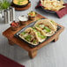 A Valor cast iron fajita skillet with tacos on a wooden tray.
