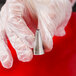 A hand in white gloves holding Ateco square piping tip.