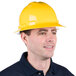 A man wearing a yellow Cordova Duo full-brim hard hat with ratchet suspension.