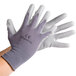 A pair of Cordova gray warehouse gloves with gray polyurethane palms.