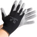 A pair of black Cordova warehouse gloves with gray palm coating.